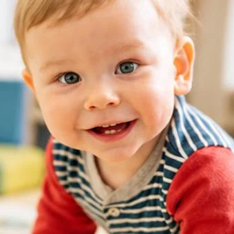 A smiling baby crawling